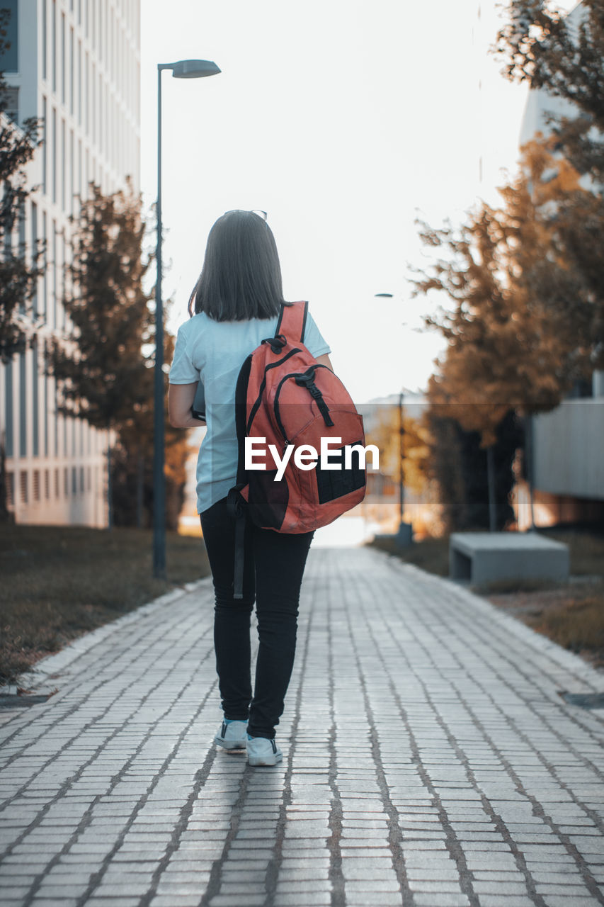 Rear view of woman walking on street