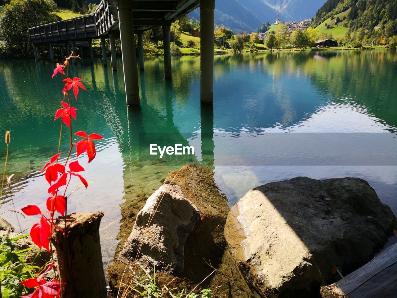 REFLECTION OF ROCKS AND TREES IN LAKE
