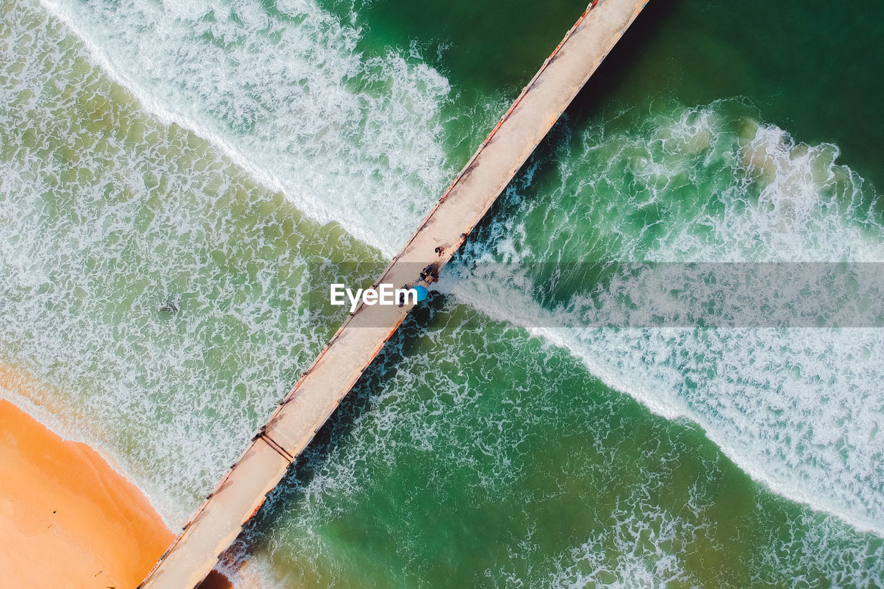 Directly above shot of people on pier over sea