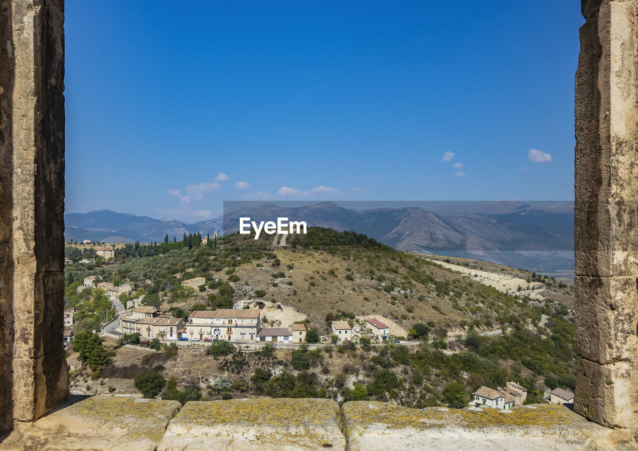 SCENIC VIEW OF LANDSCAPE AND MOUNTAINS AGAINST SKY