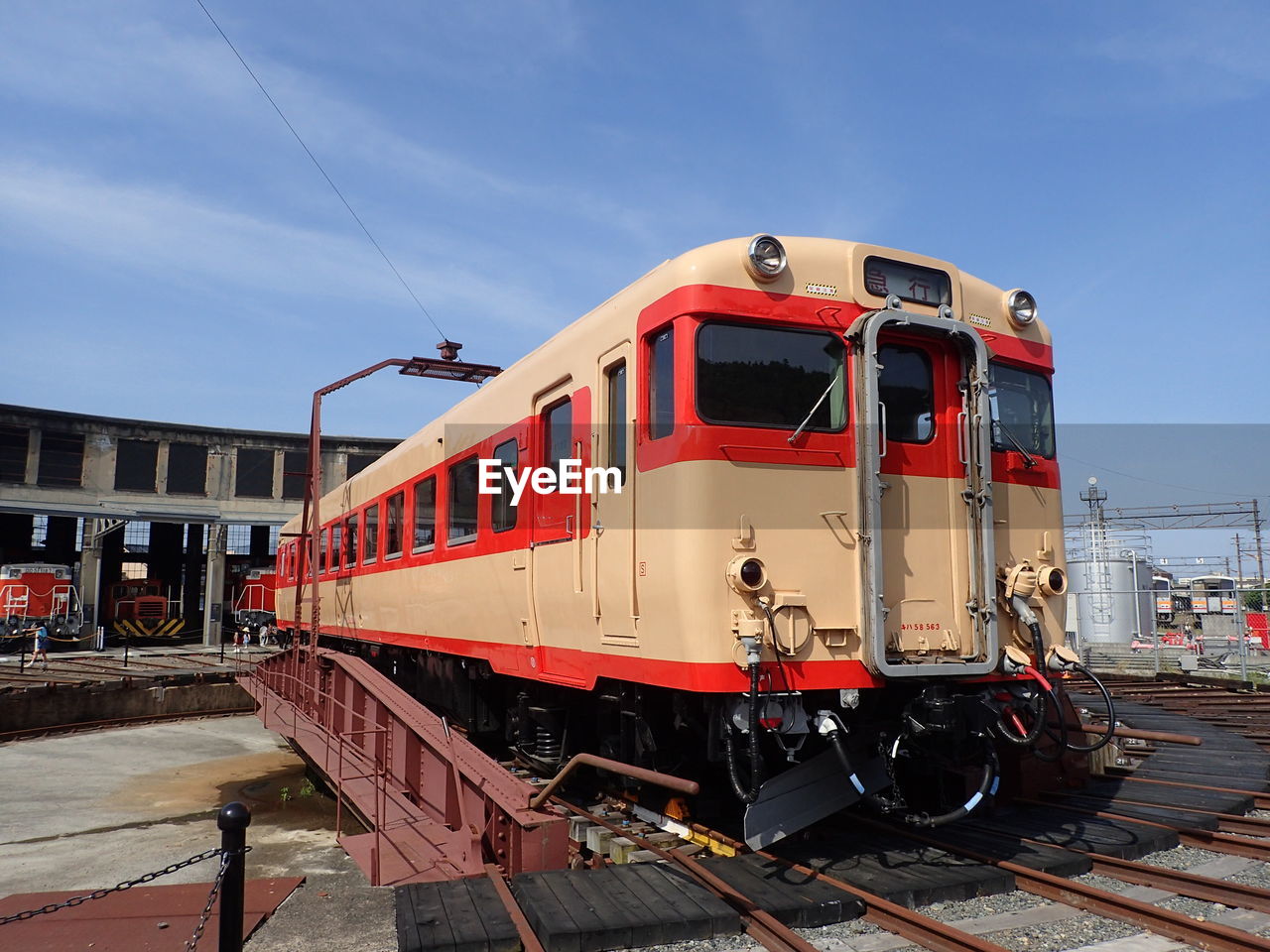 Train at rotary railroad station against sky