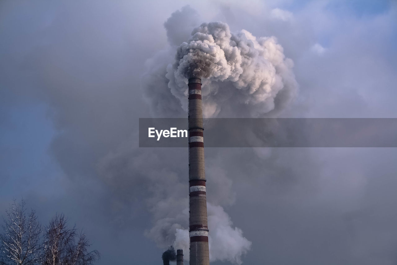 SMOKE EMITTING FROM CHIMNEY AGAINST SKY