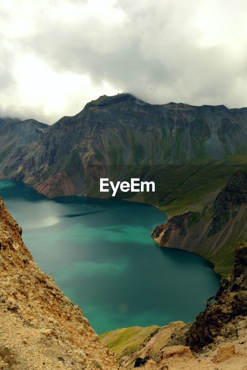 Scenic view of lake and mountains against sky