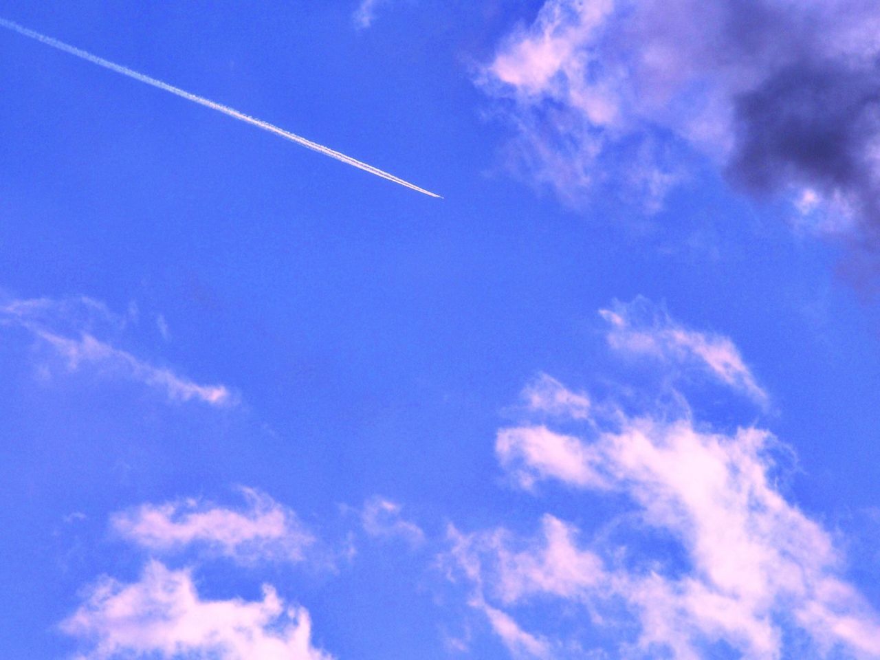 LOW ANGLE VIEW OF VAPOR TRAILS IN SKY