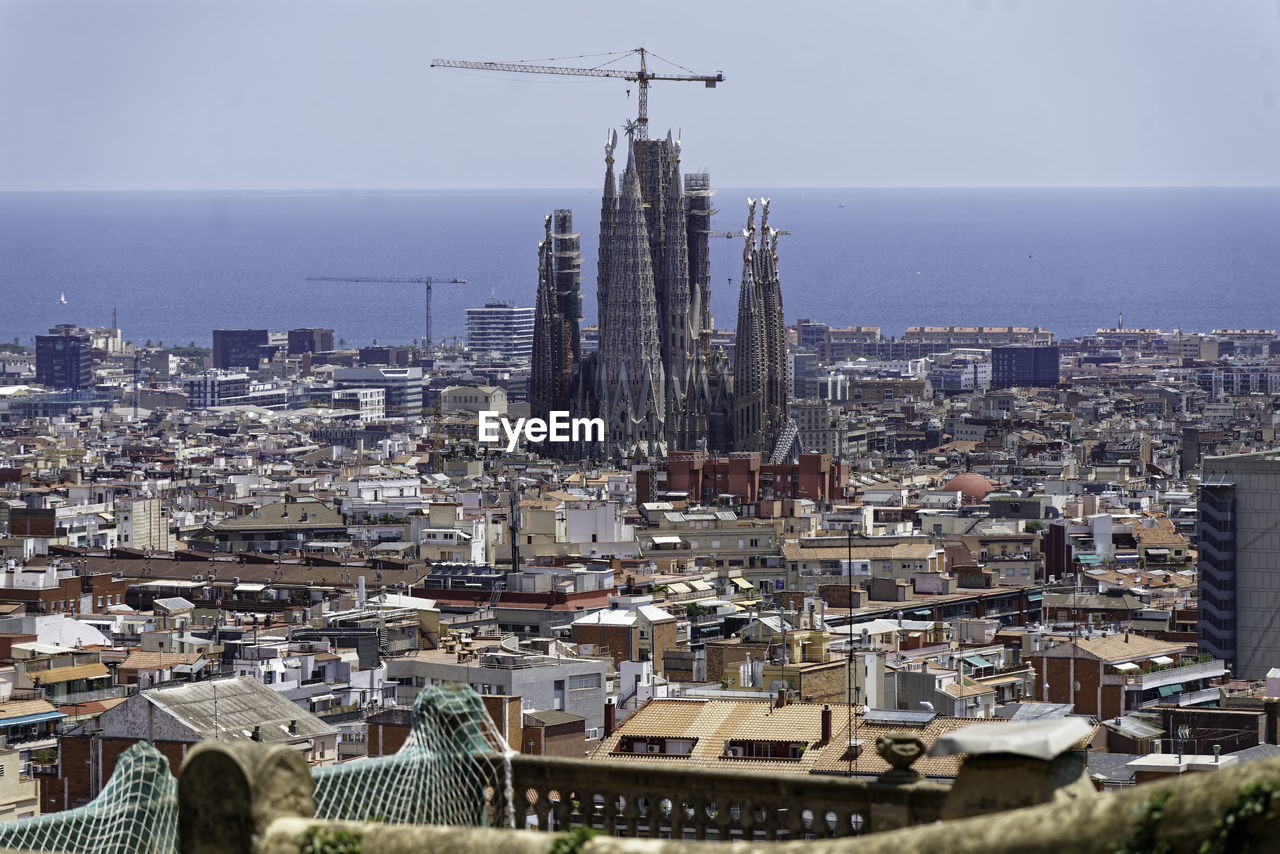 architecture, built structure, city, building exterior, cityscape, building, skyline, landmark, tower, skyscraper, aerial photography, urban area, sky, nature, metropolis, office building exterior, urban skyline, residential district, no people, landscape, high angle view, downtown, travel destinations, tower block, metropolitan area, outdoors, water, day, town, aerial view, travel, development, horizon