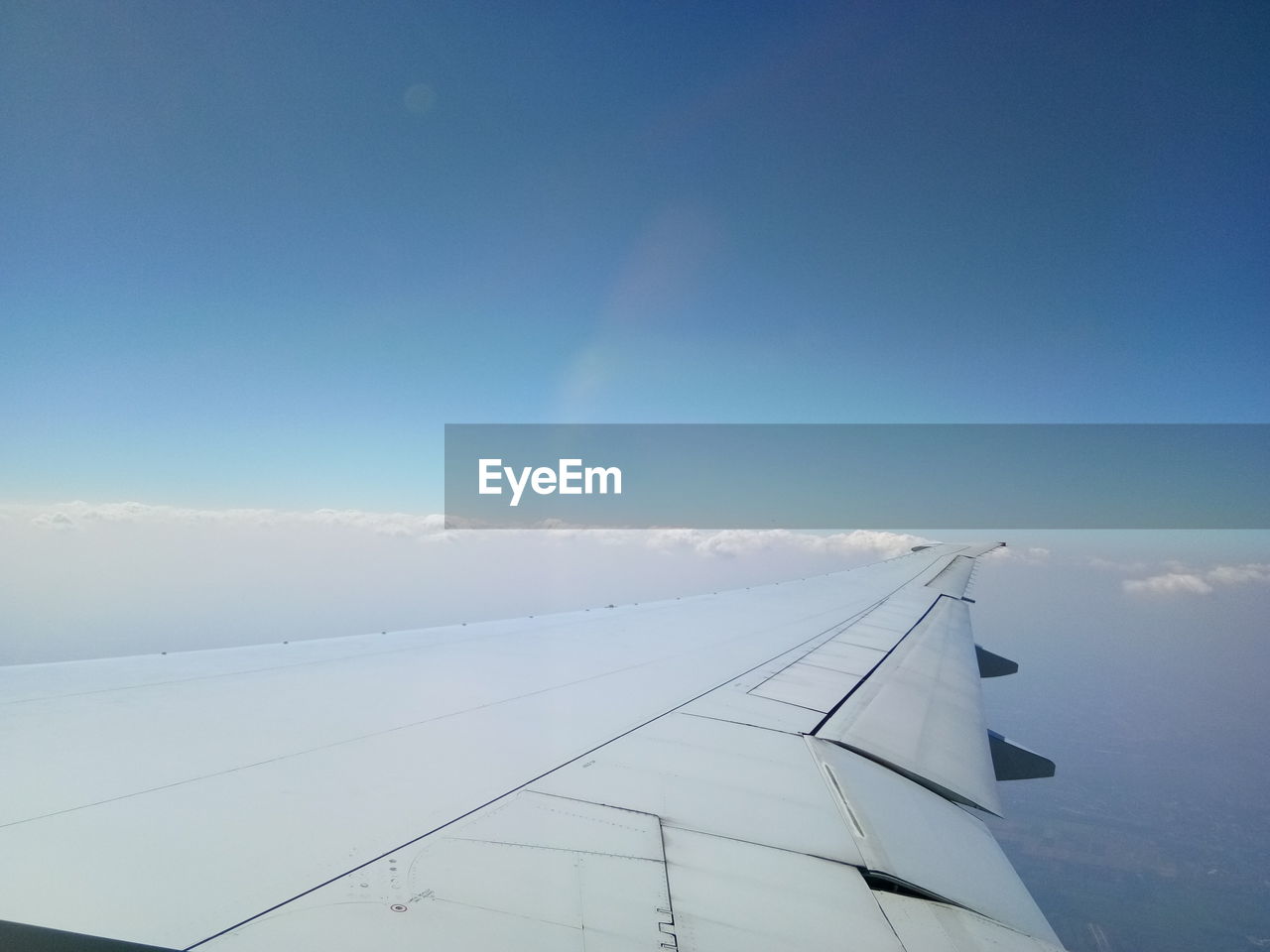 AIRPLANE FLYING AGAINST SKY