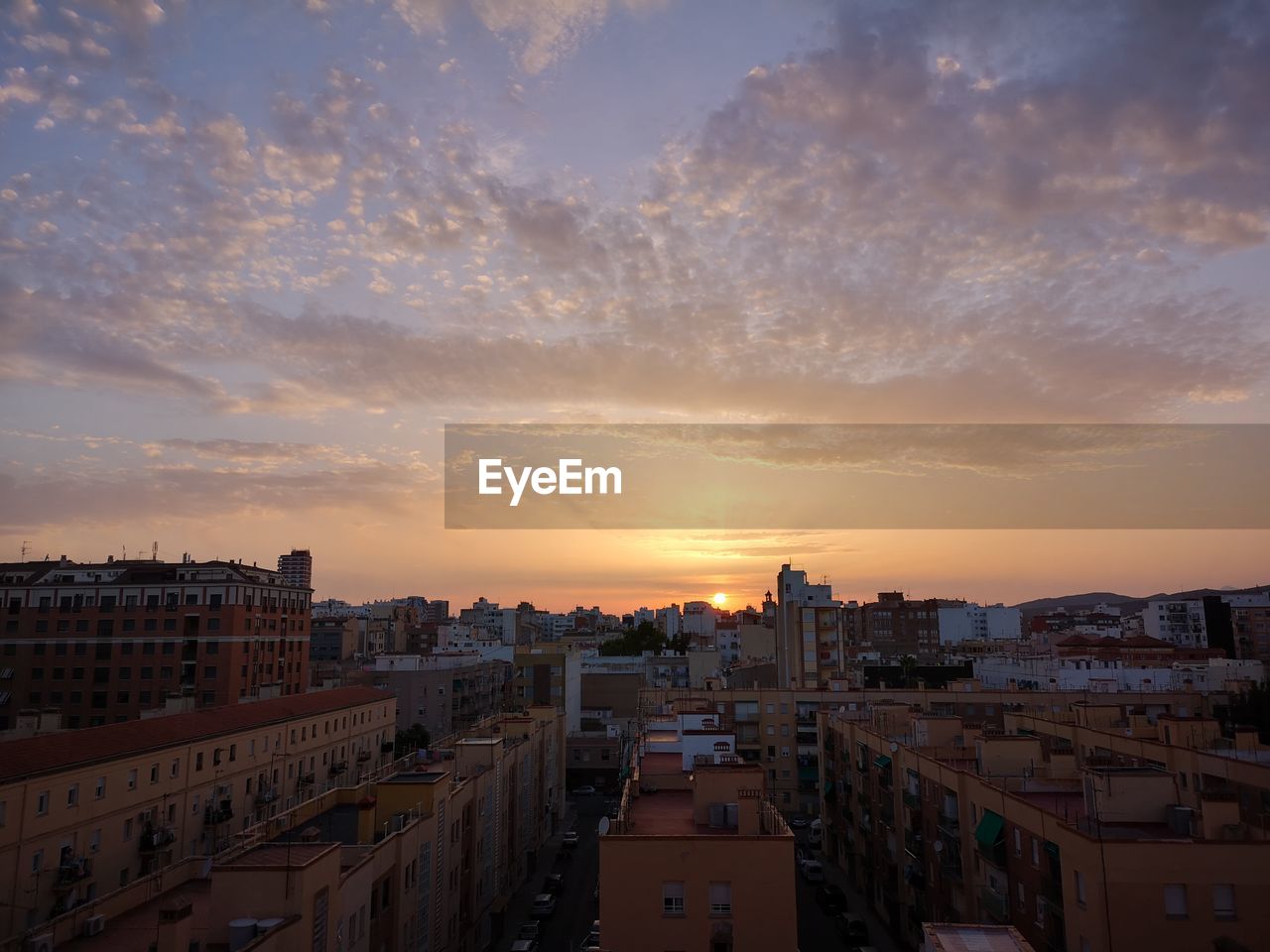 High angle view of buildings against sky during sunset