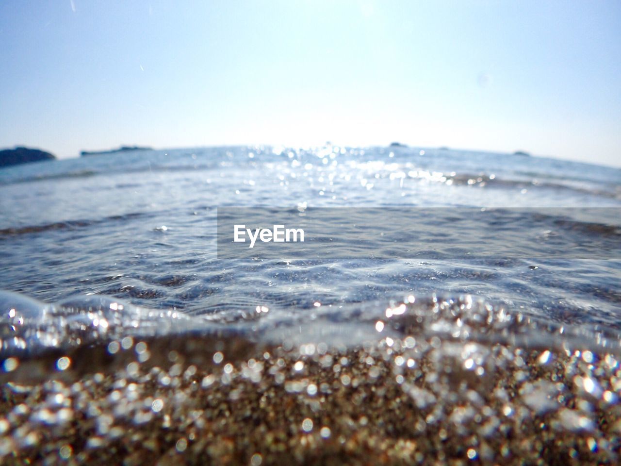 CLOSE-UP OF BEACH AGAINST SKY