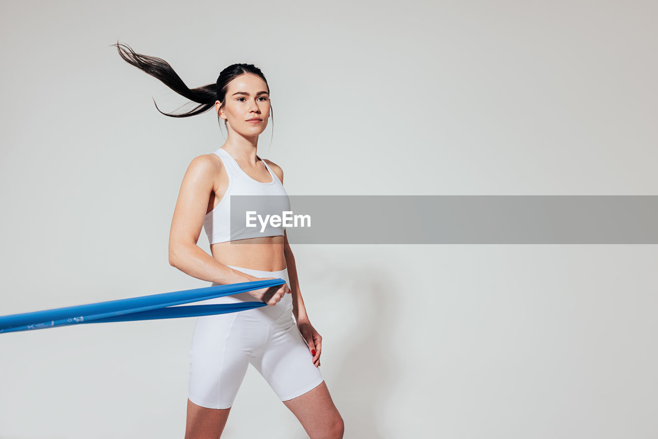 portrait of woman standing against white background