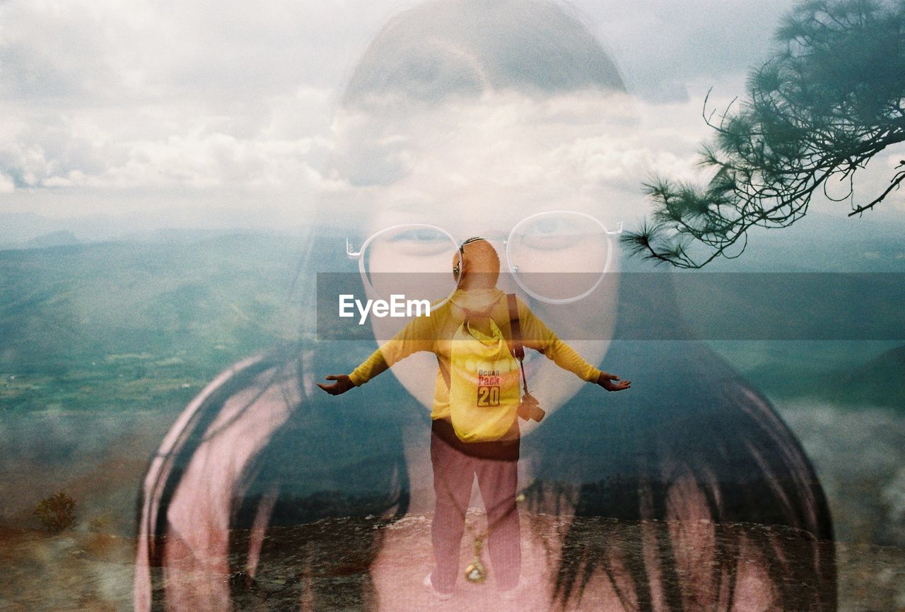 DIGITAL COMPOSITE IMAGE OF WOMAN STANDING IN WATER