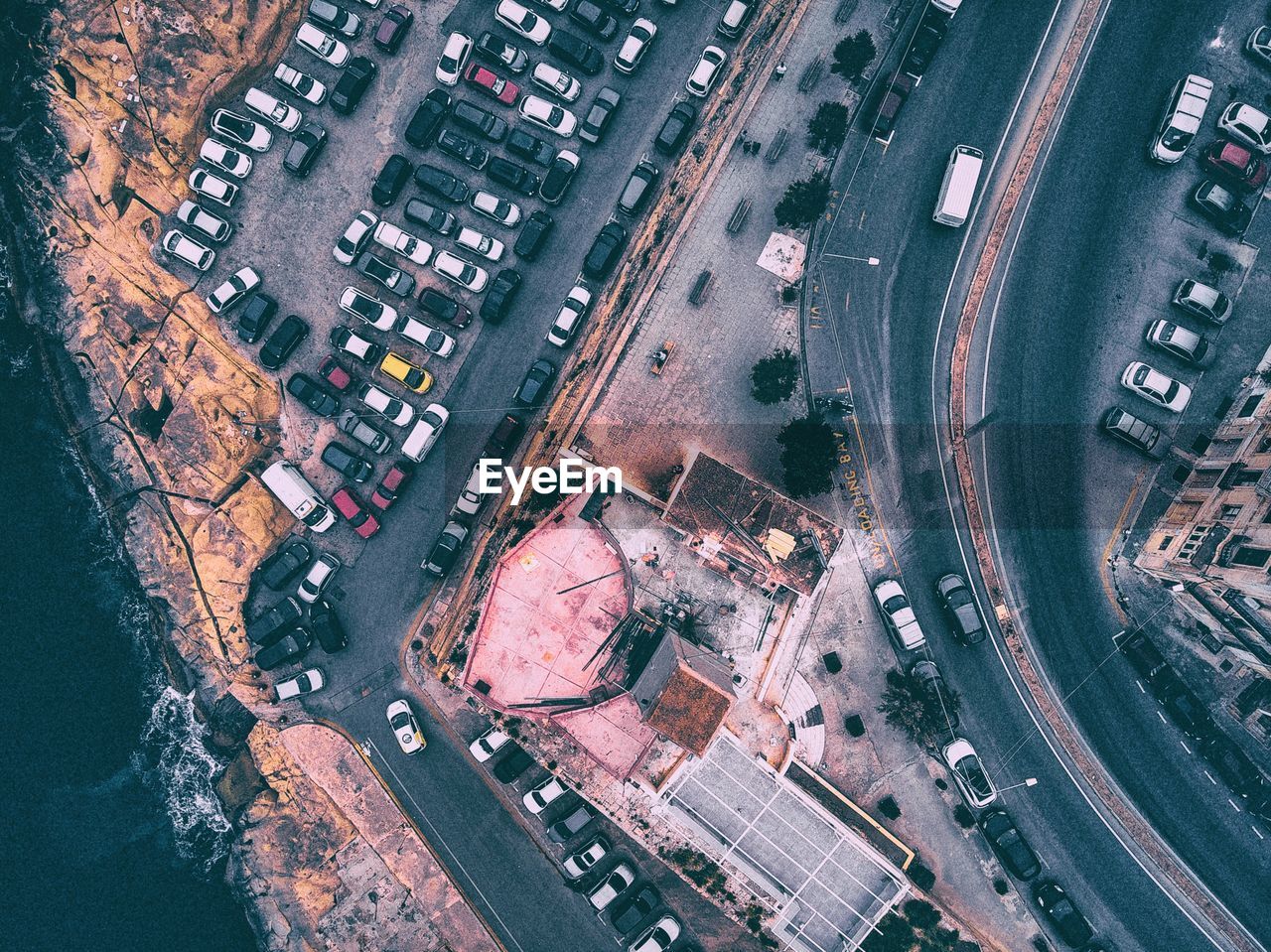 High angle view of cars parked on street amidst buildings in city