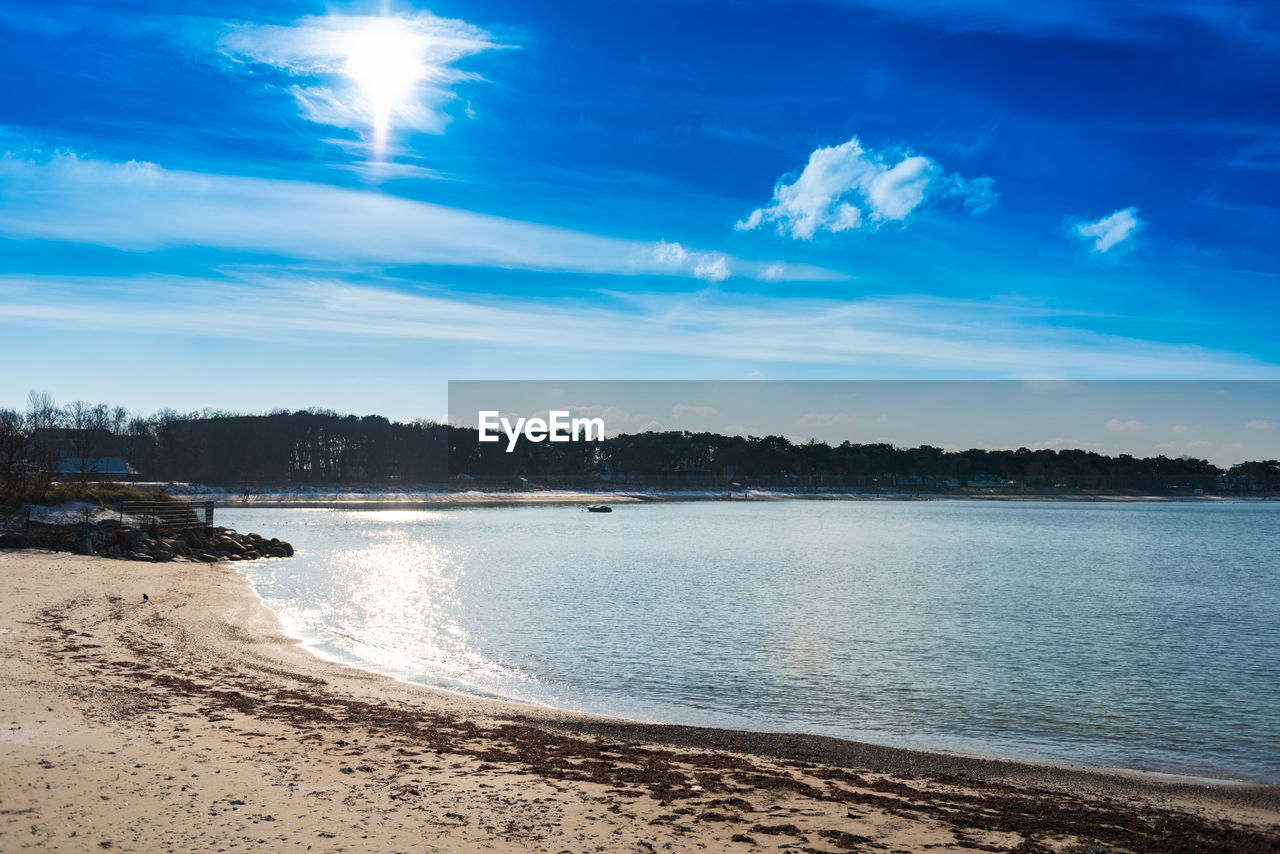 Scenic view of sea against blue sky