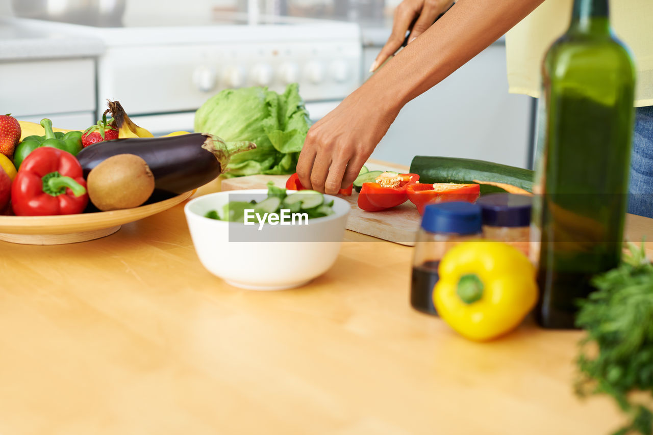 cropped hand of man preparing food in bowl on table