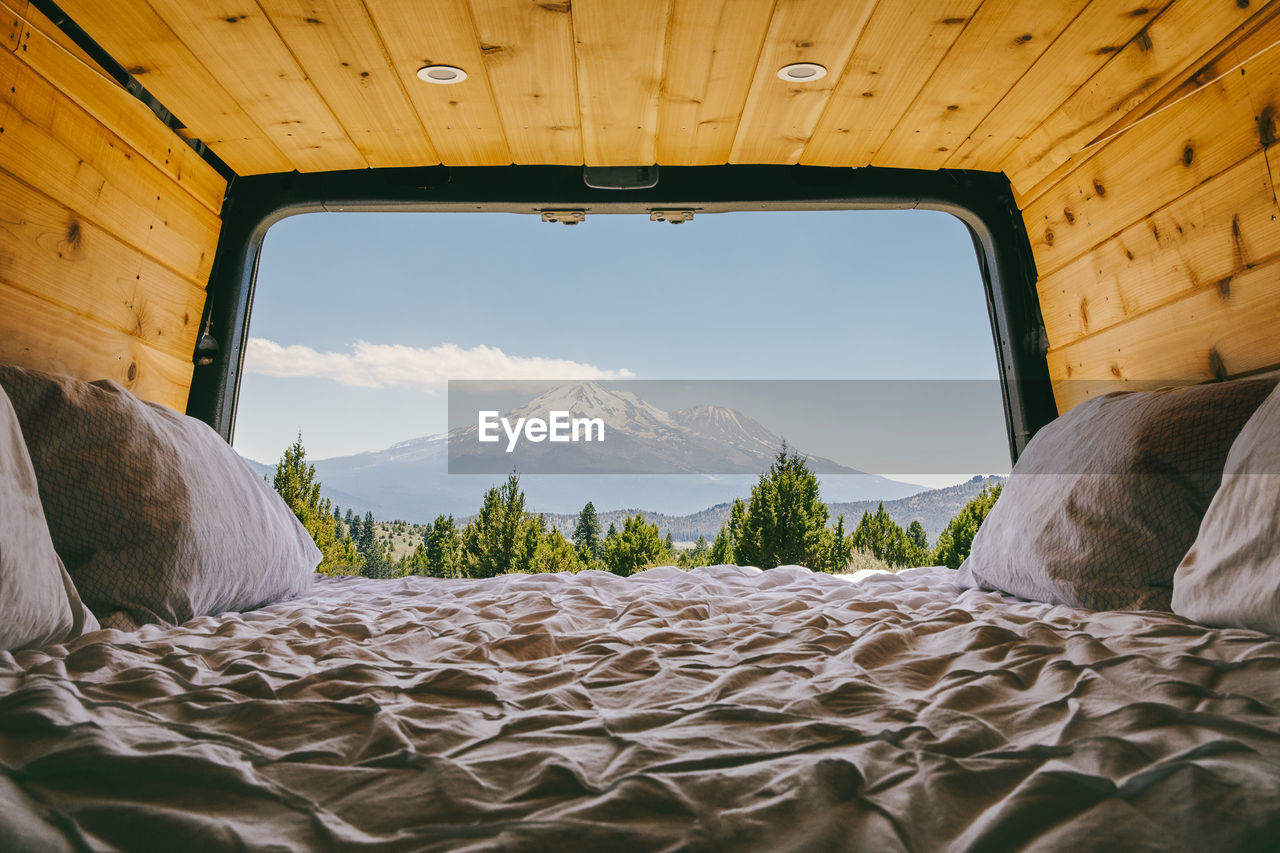 View of mount shasta from bed of camper van in oregon.