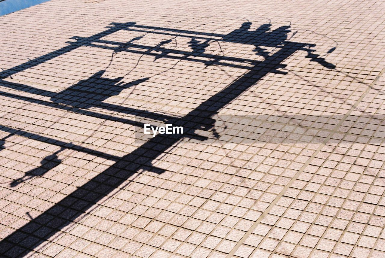 Shadow on electrical equipment on footpath