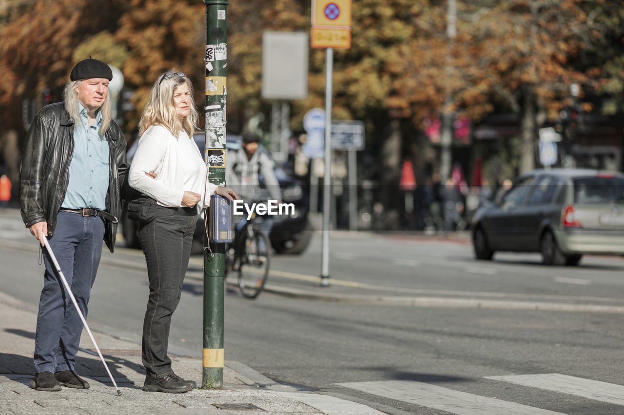 Senior couple standing at zebra crossing