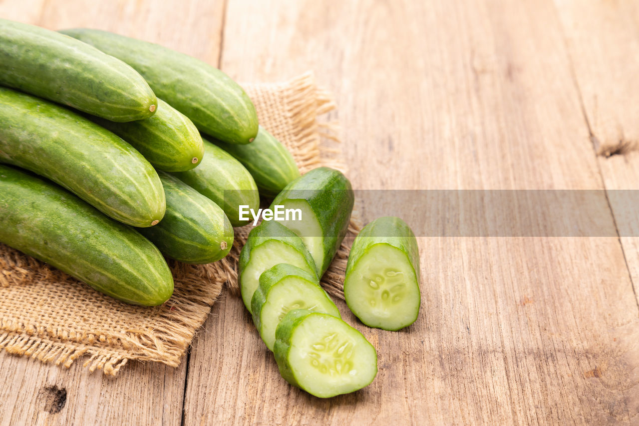 Close up pile and slice cucumber on wooden table background. food and healthcare concept