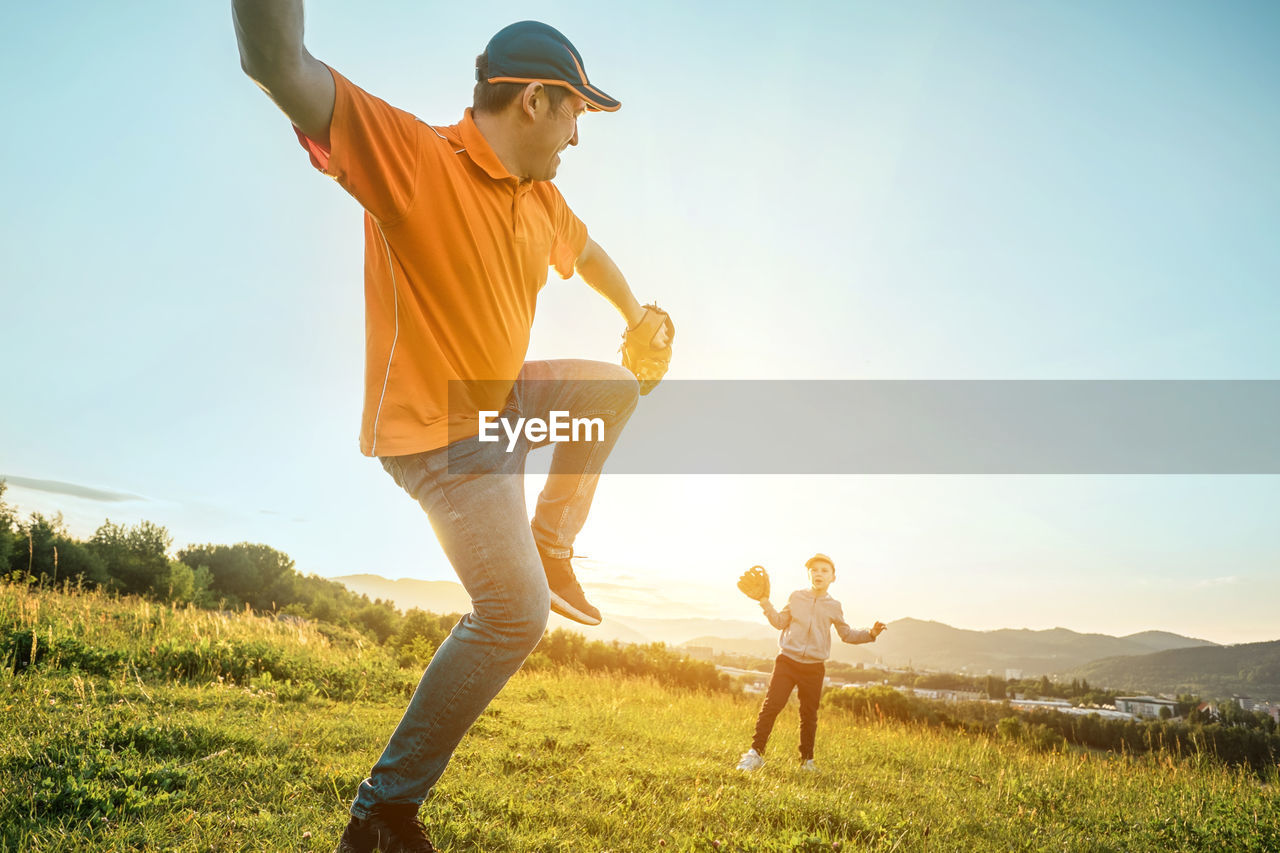 Father and son playing in baseball. man teaching boy baseballs exercise. family sports father's day.