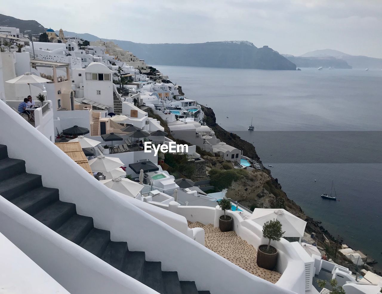 High angle view of townscape by sea against sky