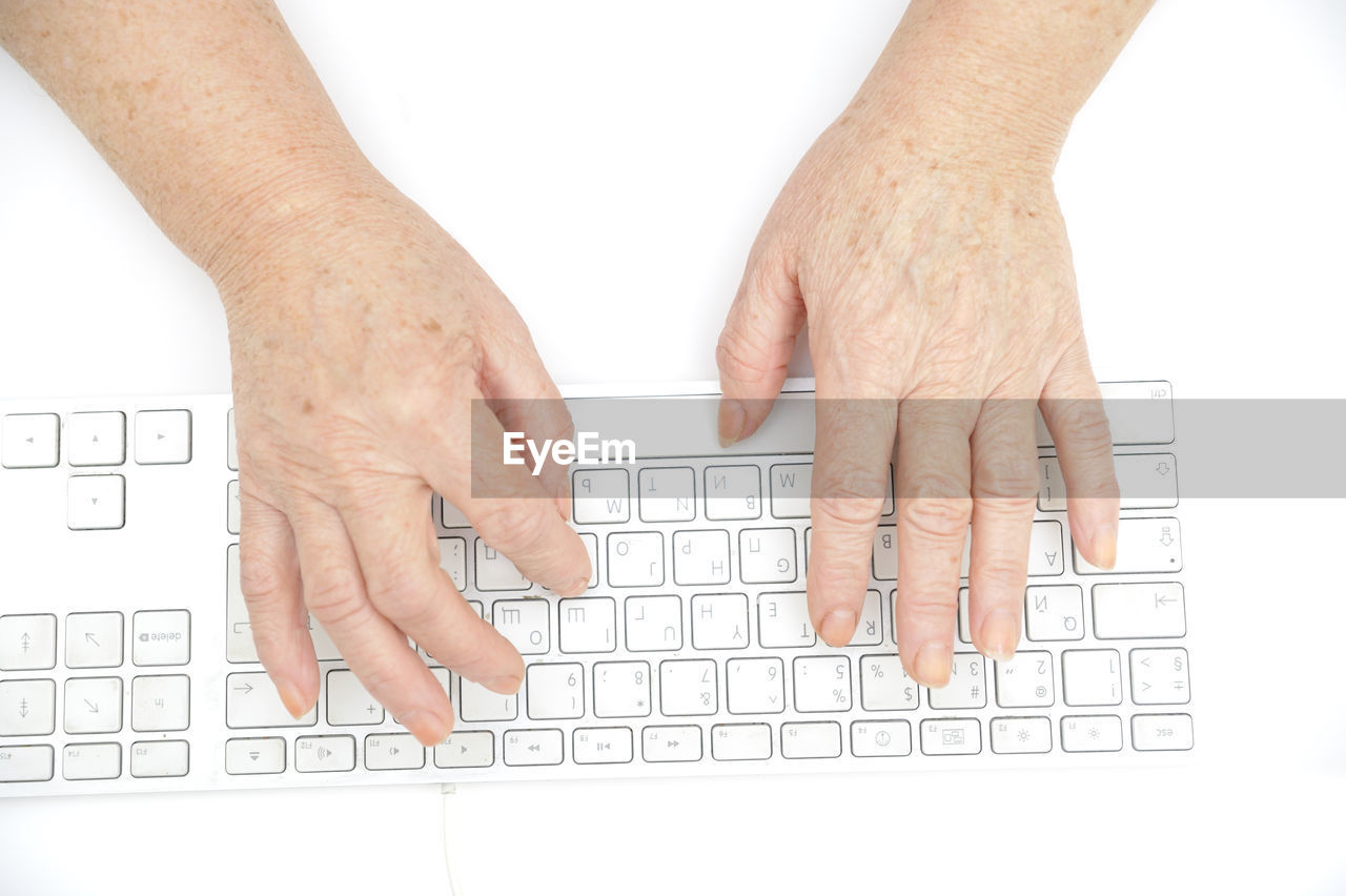 Cropped image of person typing on computer keyboard