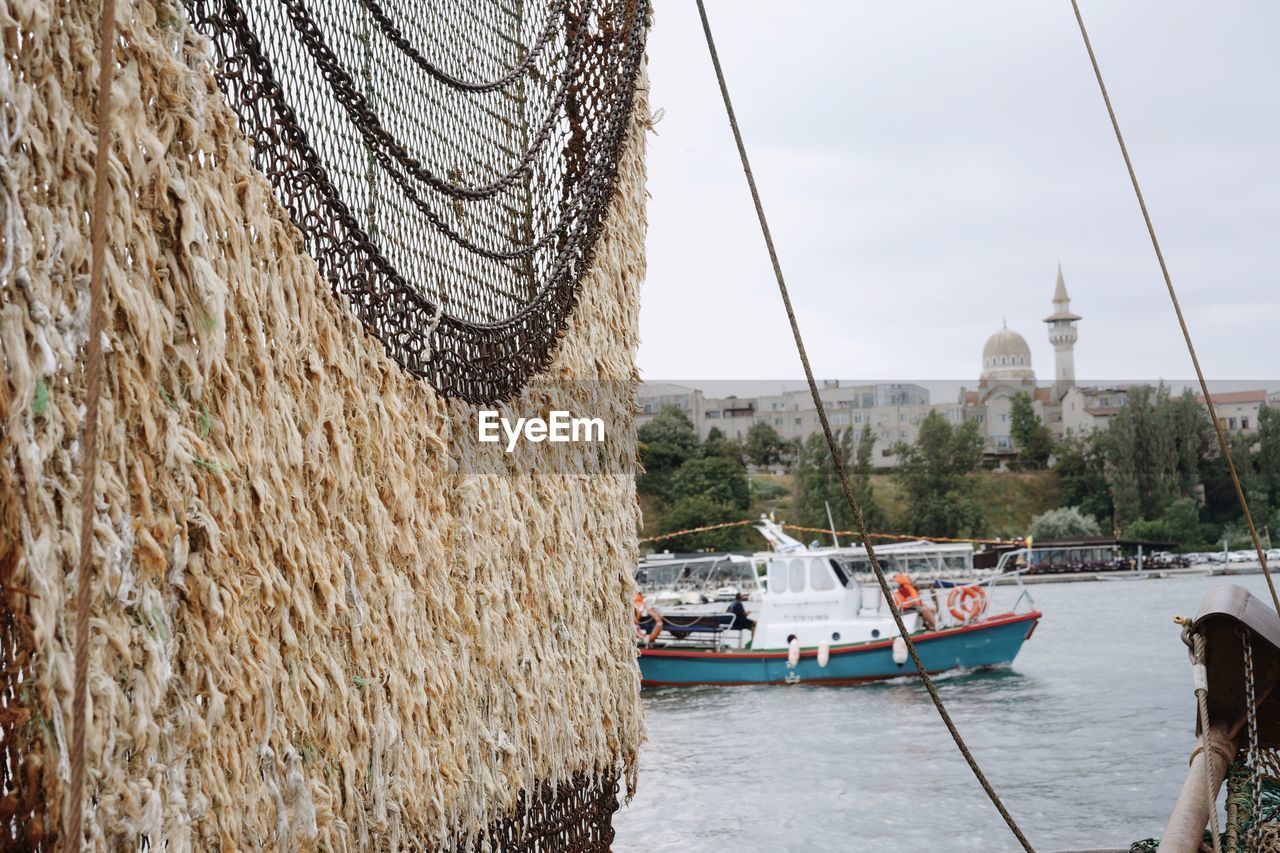 Fish drying at sea against sky