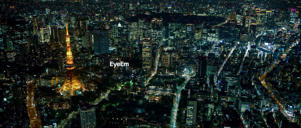 High angle view of illuminated modern buildings in city at night