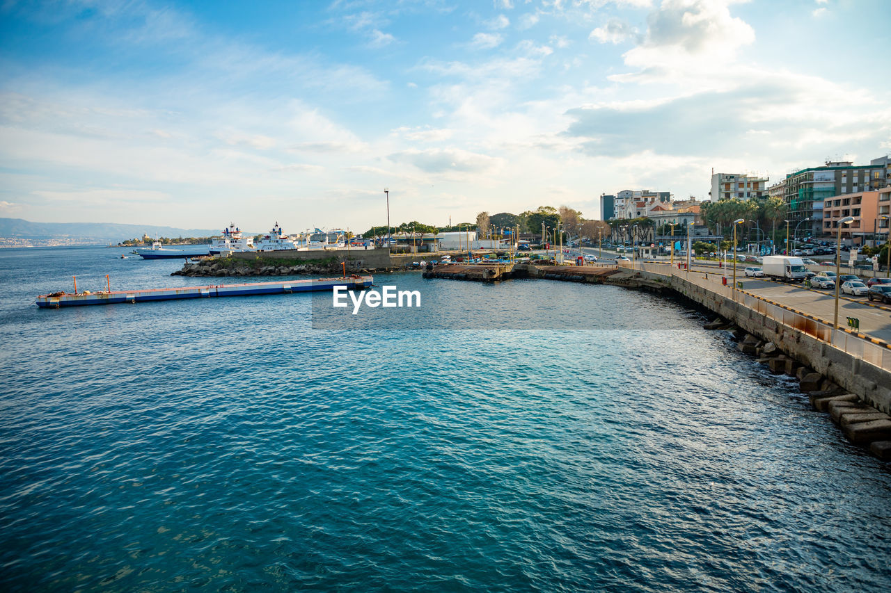 Panoramic view of sea and buildings against sky