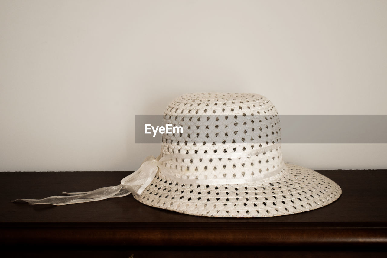 CLOSE-UP OF HAT ON TABLE AT HOME