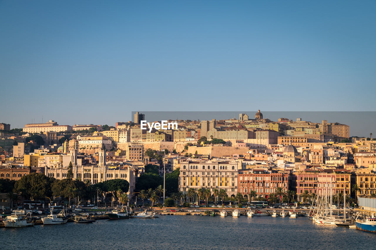 BUILDINGS BY SEA AGAINST CLEAR SKY