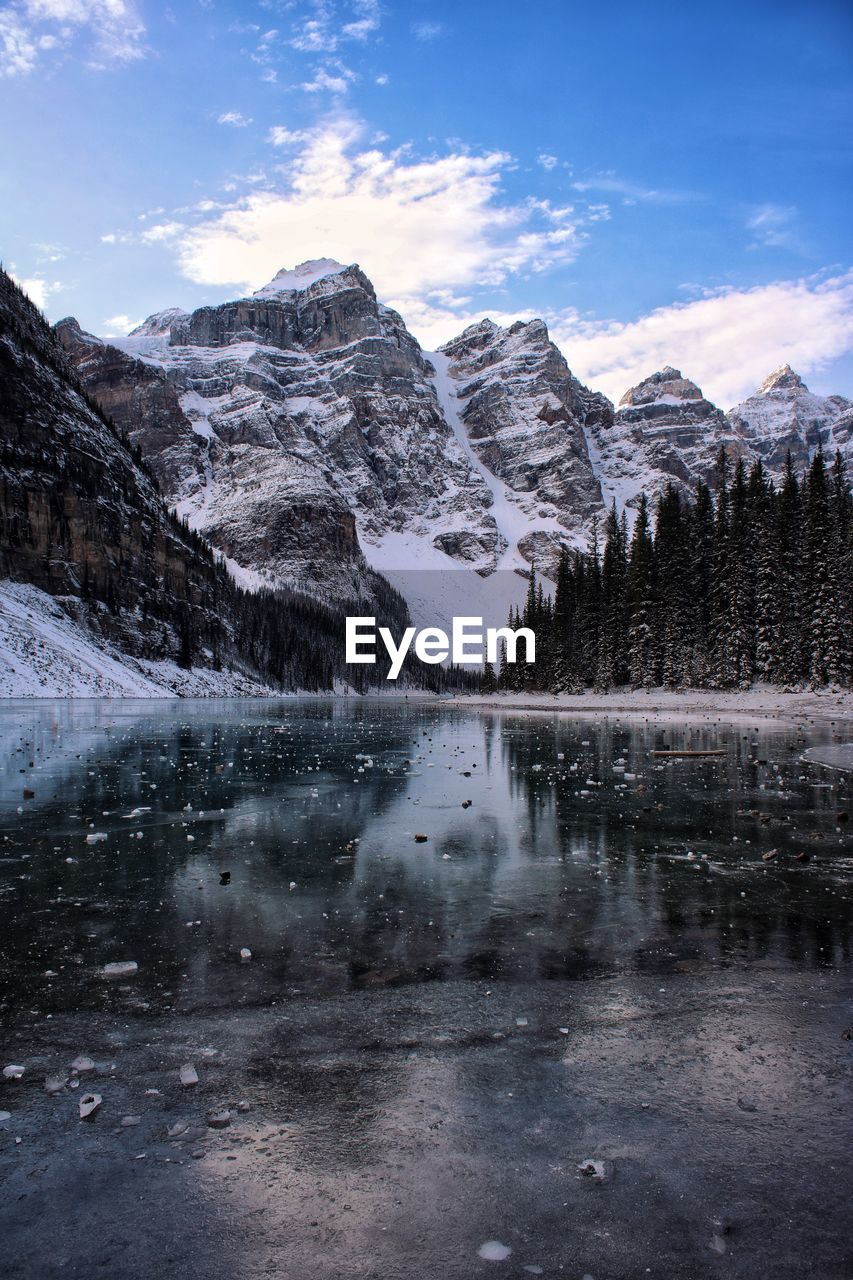 Scenic view of lake and snowcapped mountains against sky