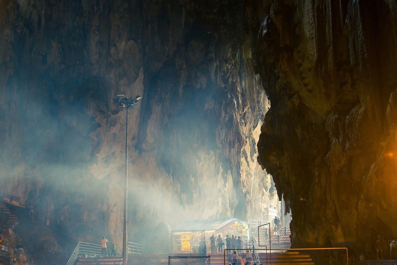 People on stairs in cave