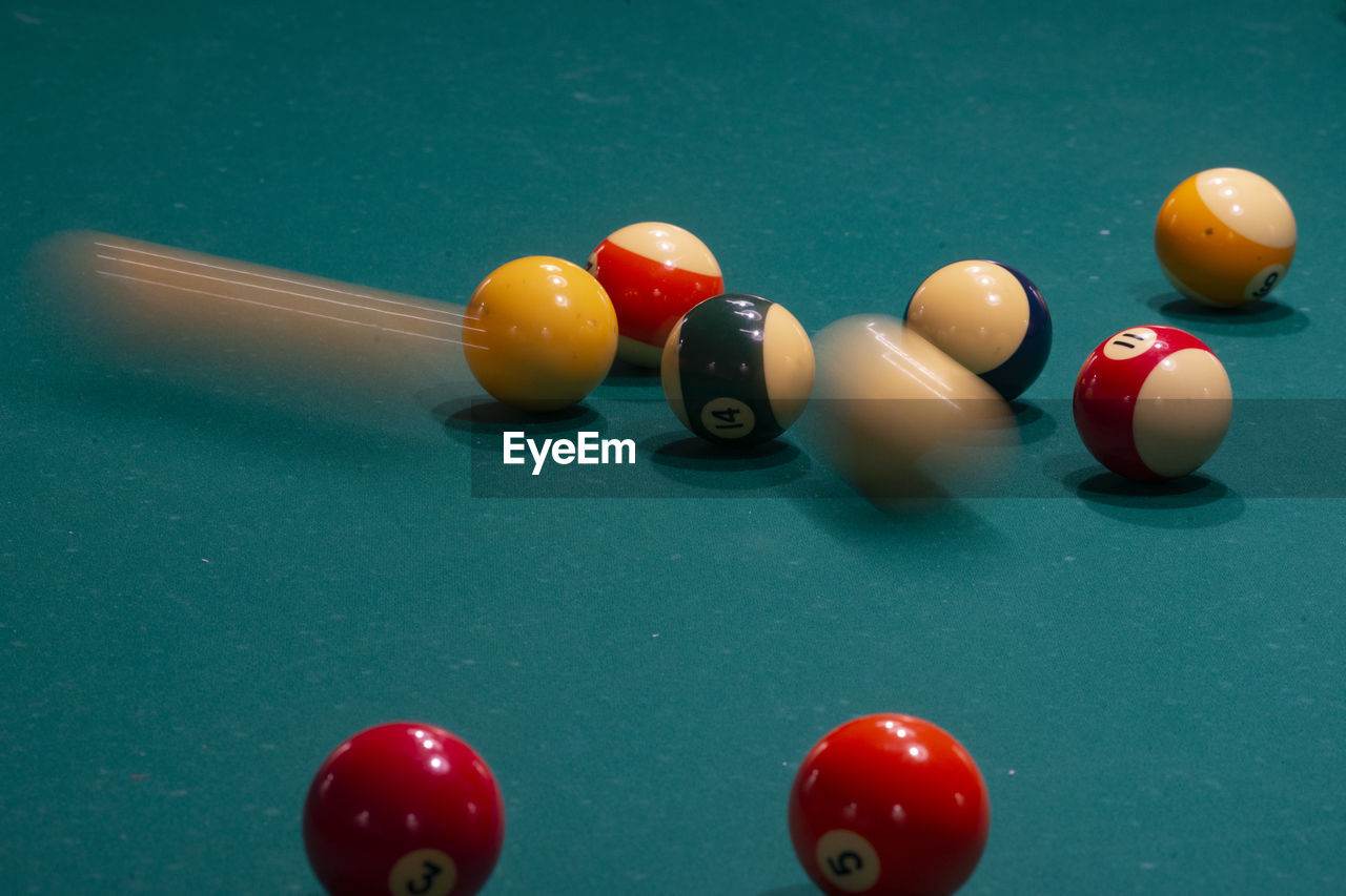 Blurred motion of pool balls on table