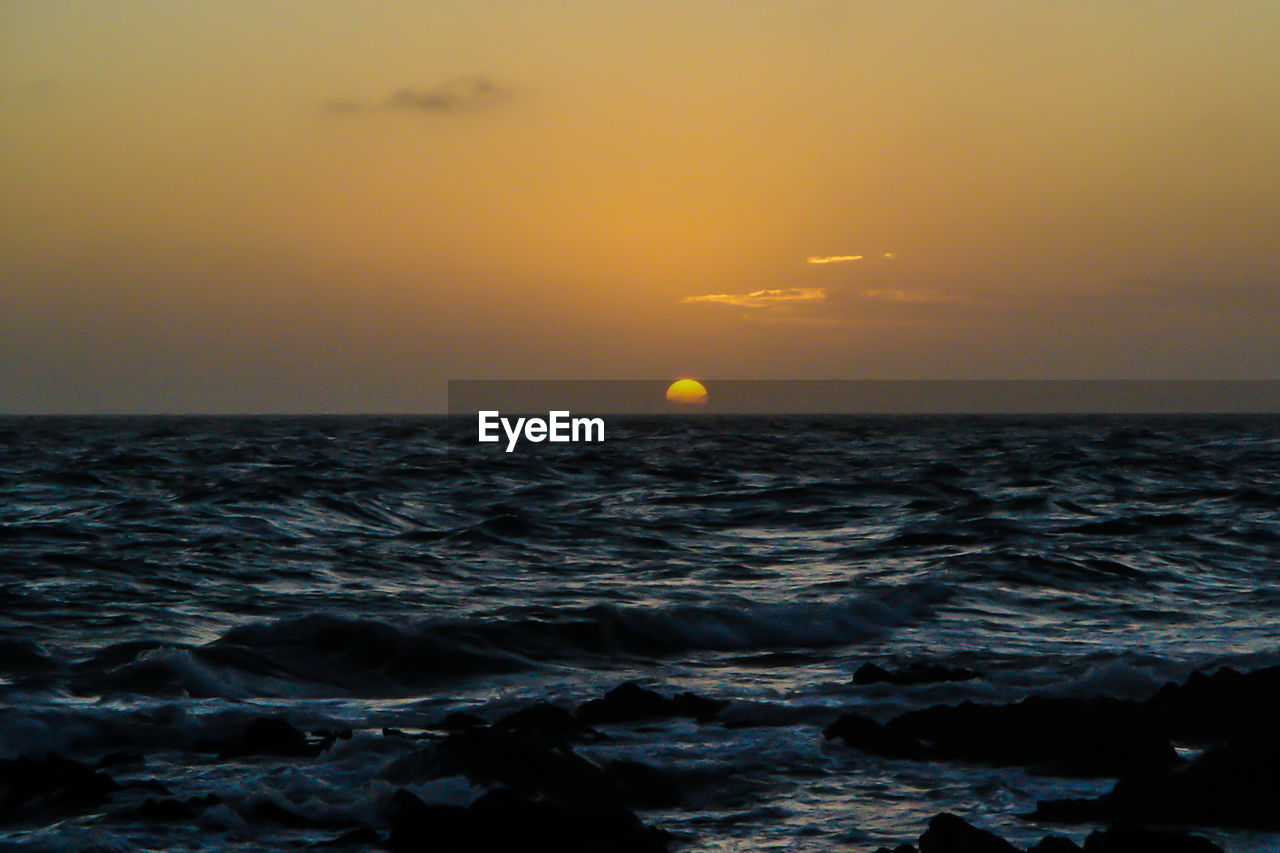 SEA AGAINST SKY DURING SUNSET