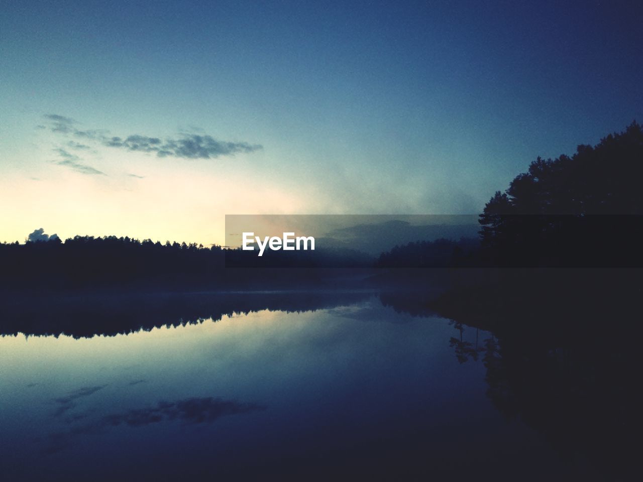 SILHOUETTE TREES BY LAKE AGAINST SKY