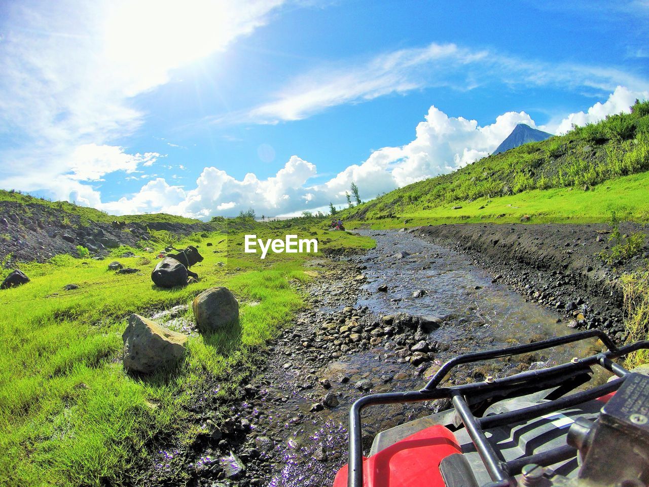 Scenic view of green mountains against sky