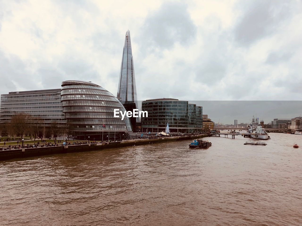 View of buildings in city against cloudy sky