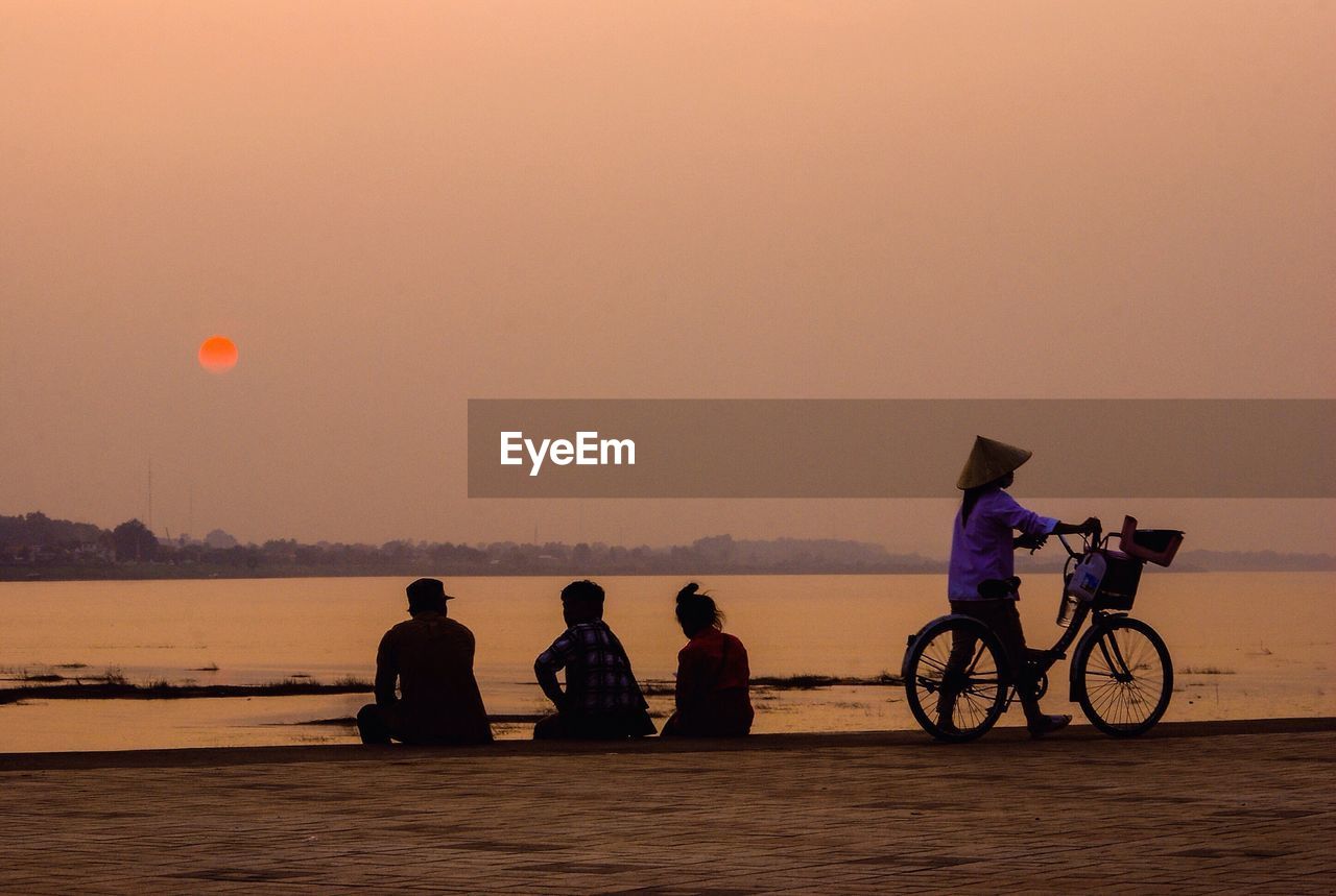 SILHOUETTE OF MAN RIDING BICYCLE