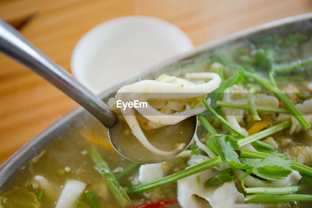 CLOSE-UP OF SOUP IN BOWL ON TABLE