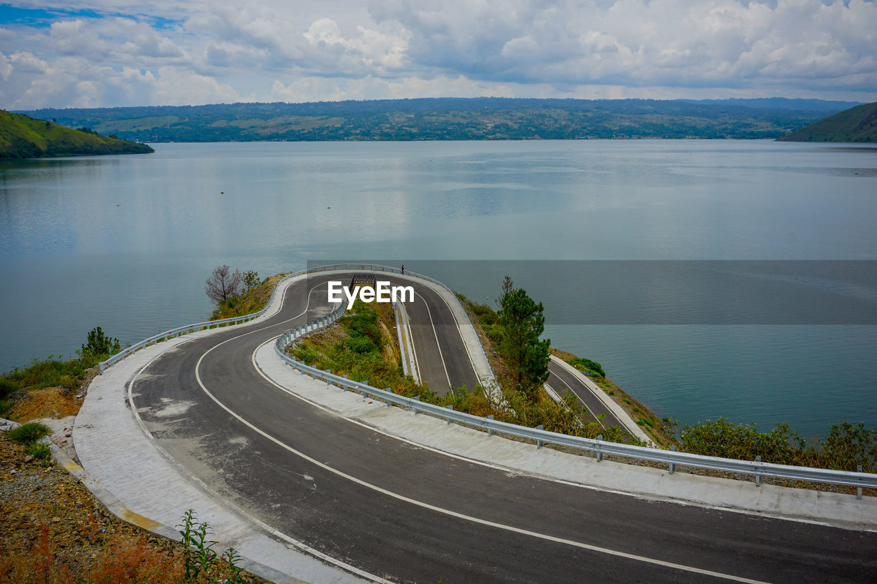 High angle view of road by sea against sky