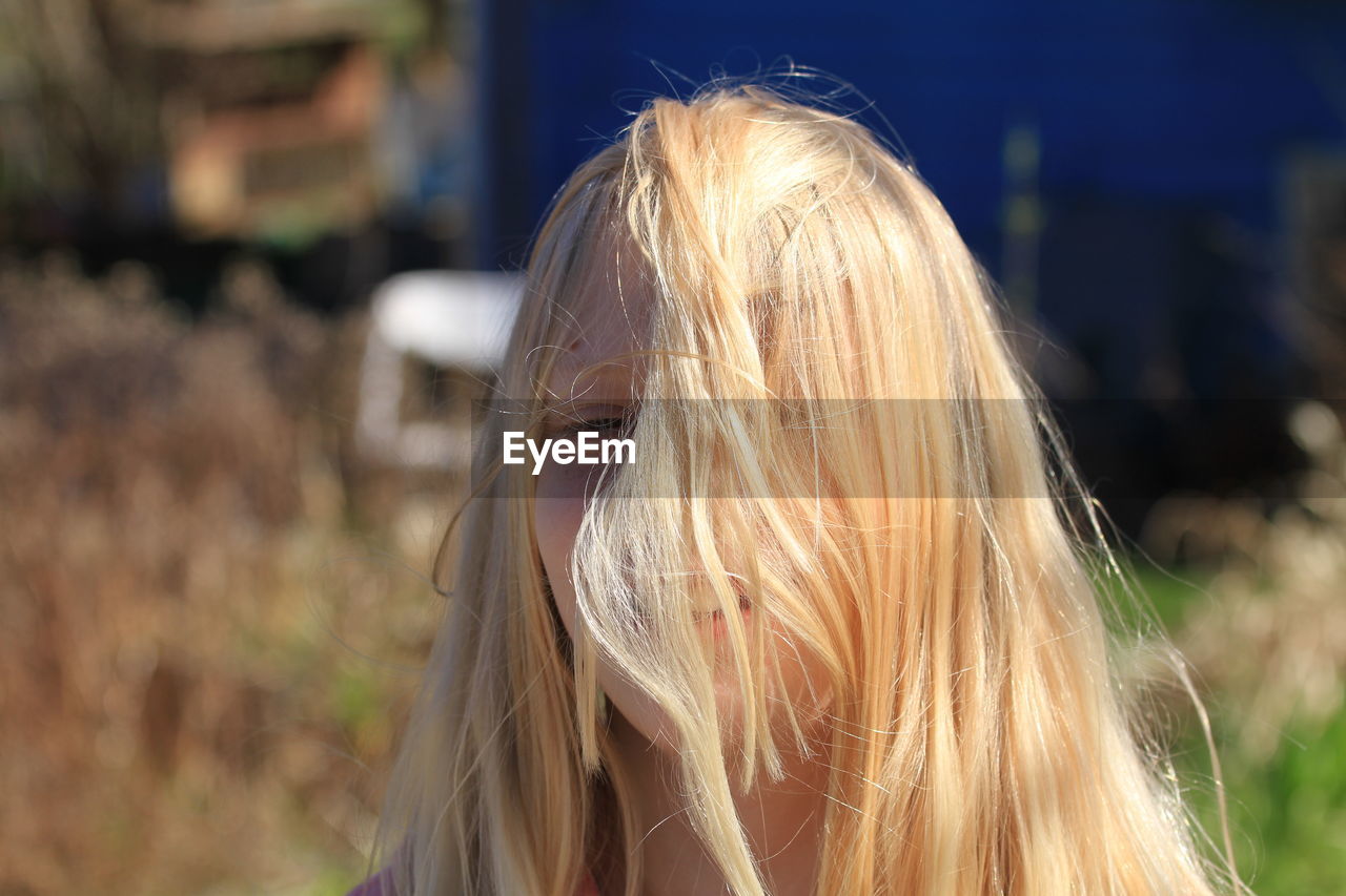 Smiling blond hair girl on field