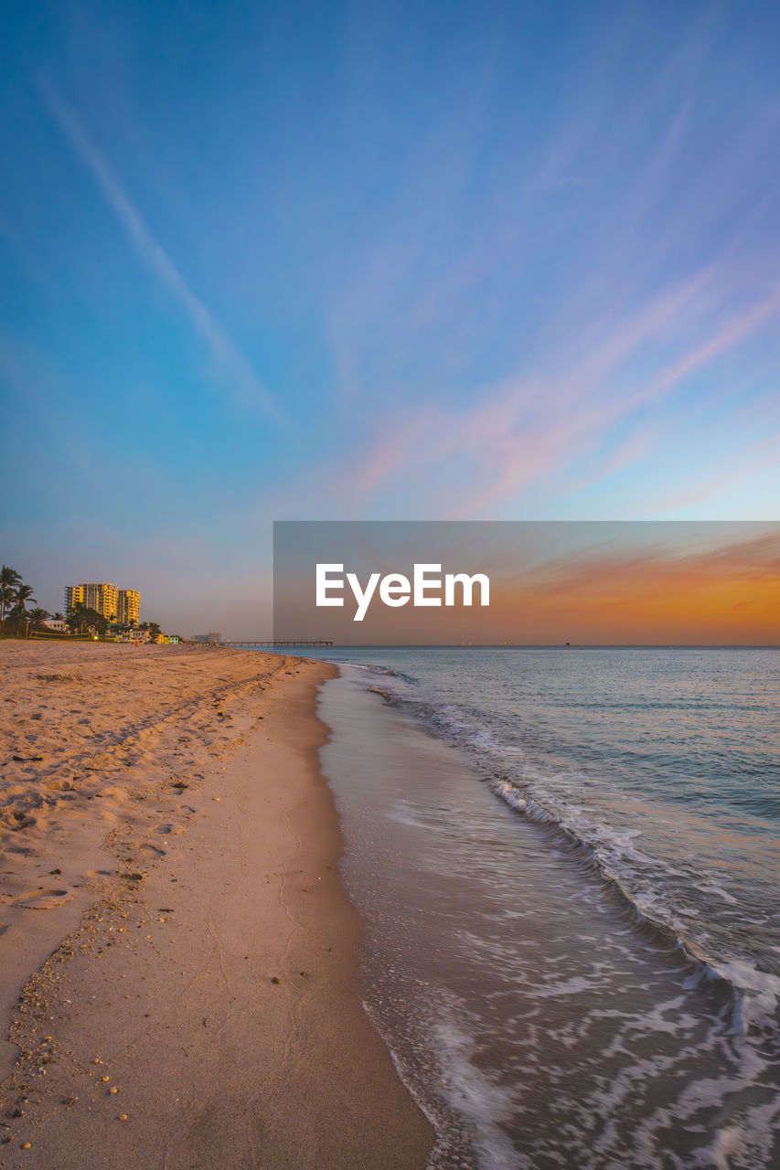 sky, land, sea, beach, water, horizon, sand, scenics - nature, sunset, beauty in nature, nature, ocean, body of water, shore, cloud, tranquility, horizon over water, coast, wave, tranquil scene, motion, wind wave, dawn, blue, environment, no people, travel destinations, natural environment, coastline, orange color, landscape, idyllic, outdoors, travel, seascape, sunlight, sun, dramatic sky, water's edge, non-urban scene, tourism, architecture, holiday