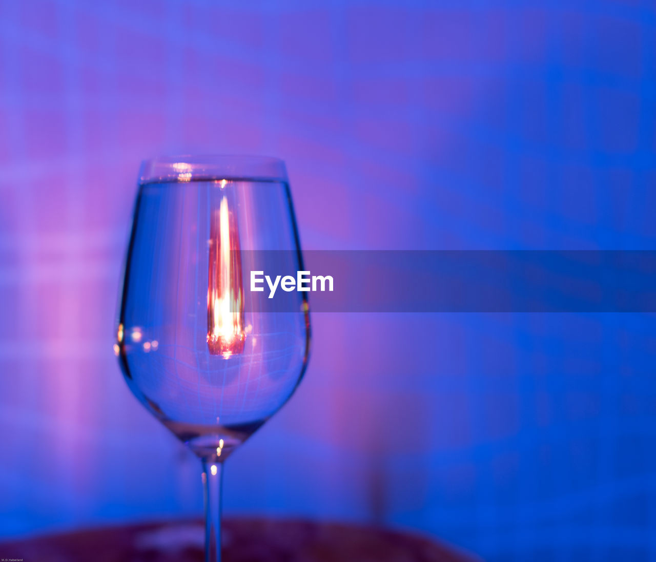 CLOSE-UP OF ILLUMINATED WINE GLASSES