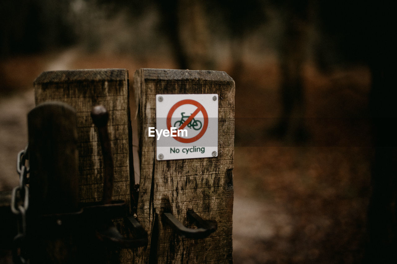 No cycling sign on a wooden gate post outdoors