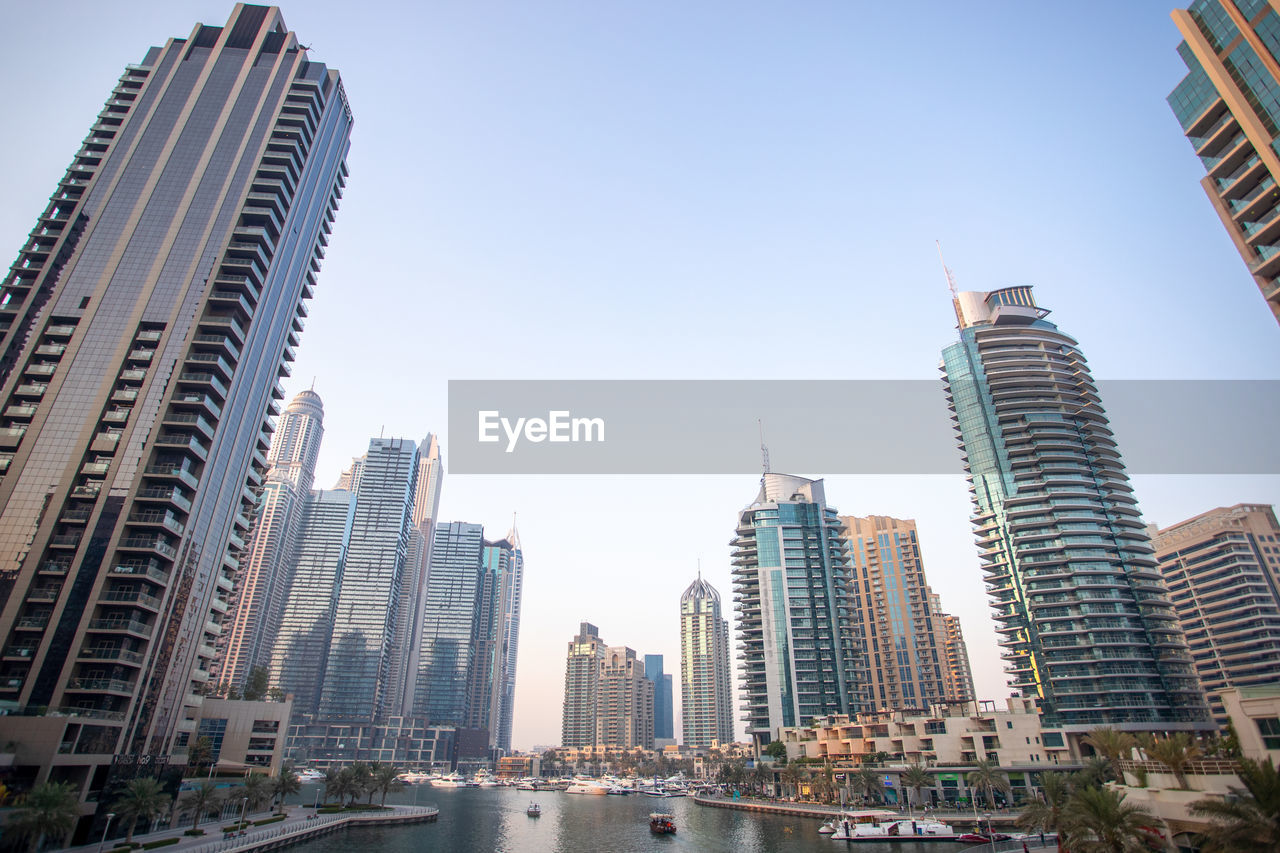 Low angle view of buildings in city against sky. dubai marina