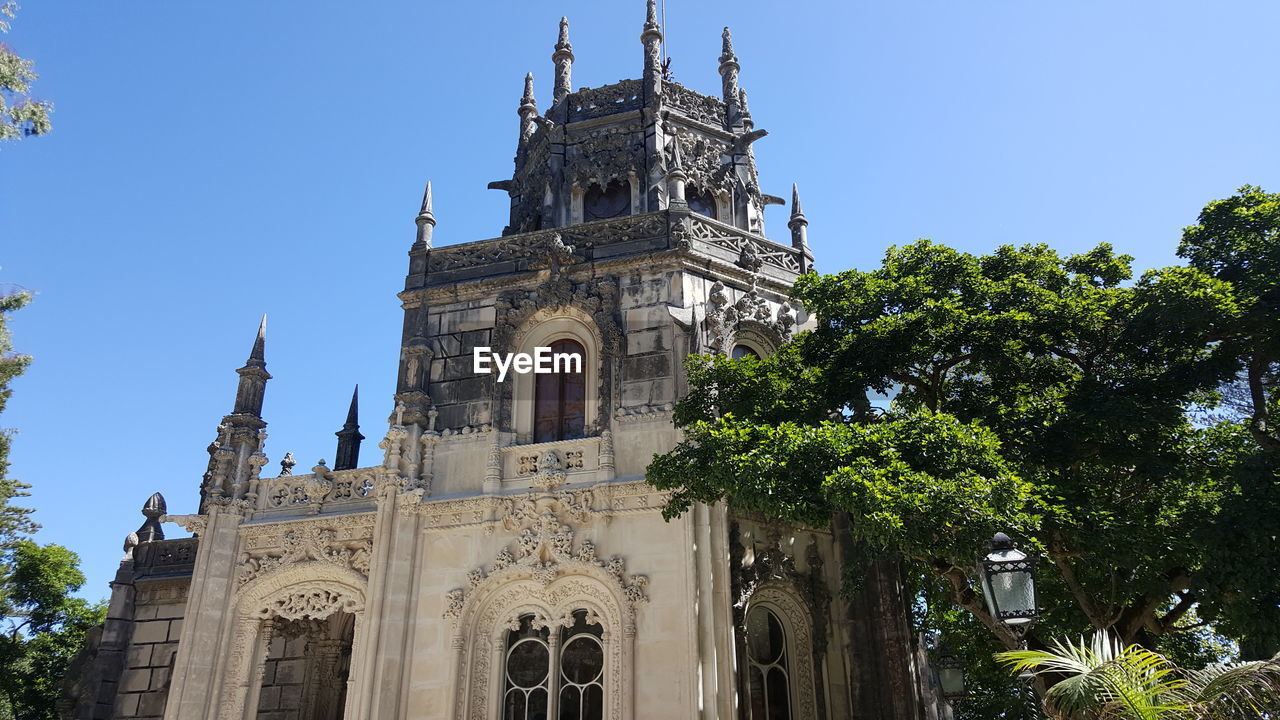 LOW ANGLE VIEW OF TEMPLE AGAINST CLEAR BLUE SKY