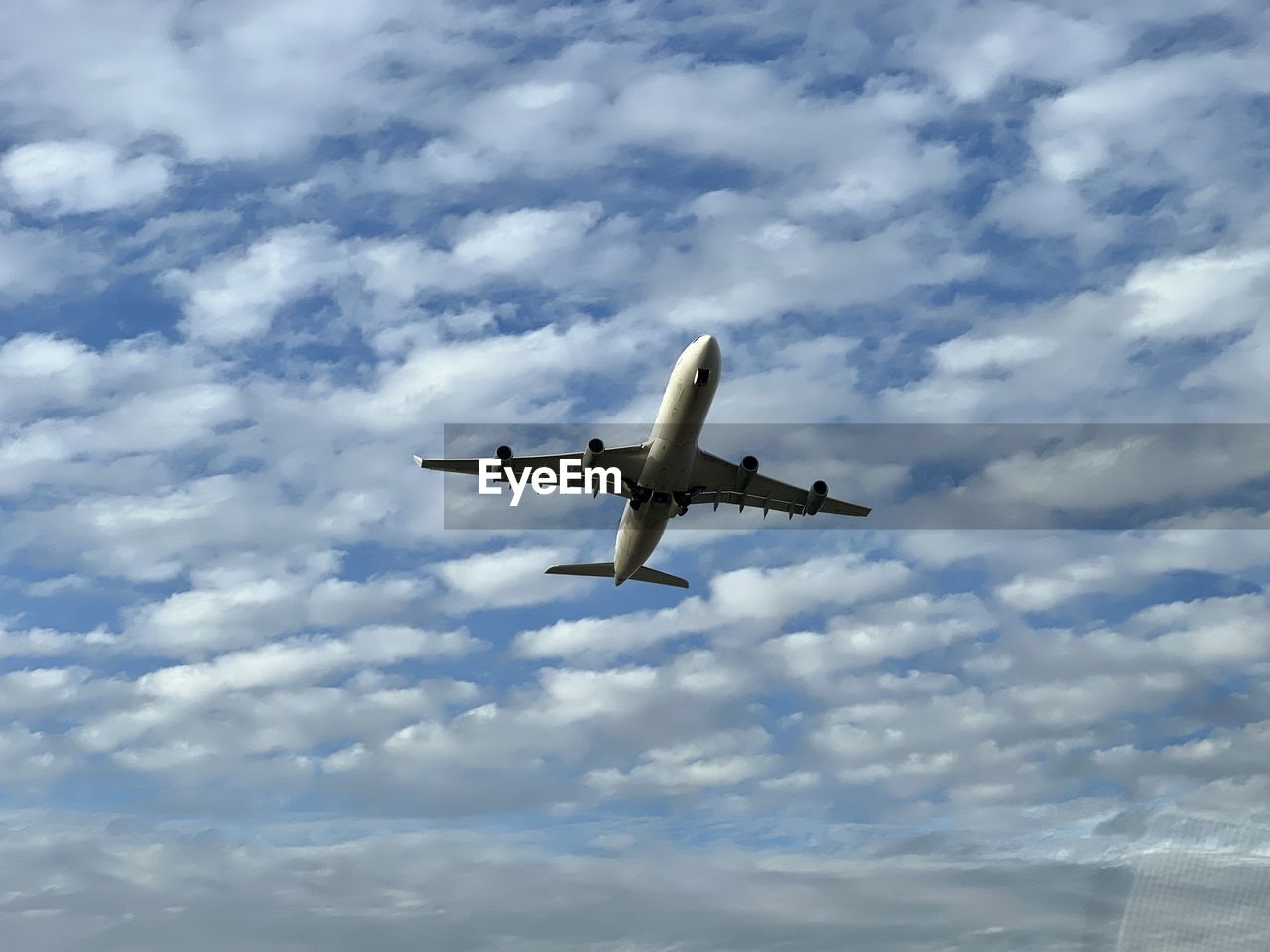 Low angle view of airplane flying against sky