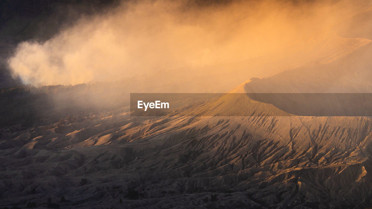 Scenic view of land against sky during sunset