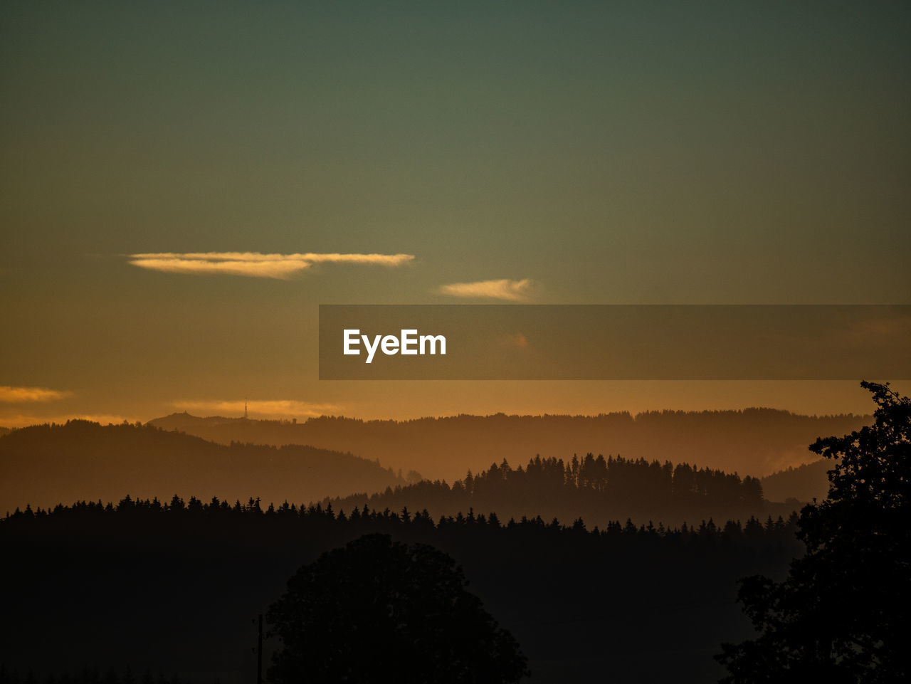 Scenic view of silhouette trees against sky during sunset