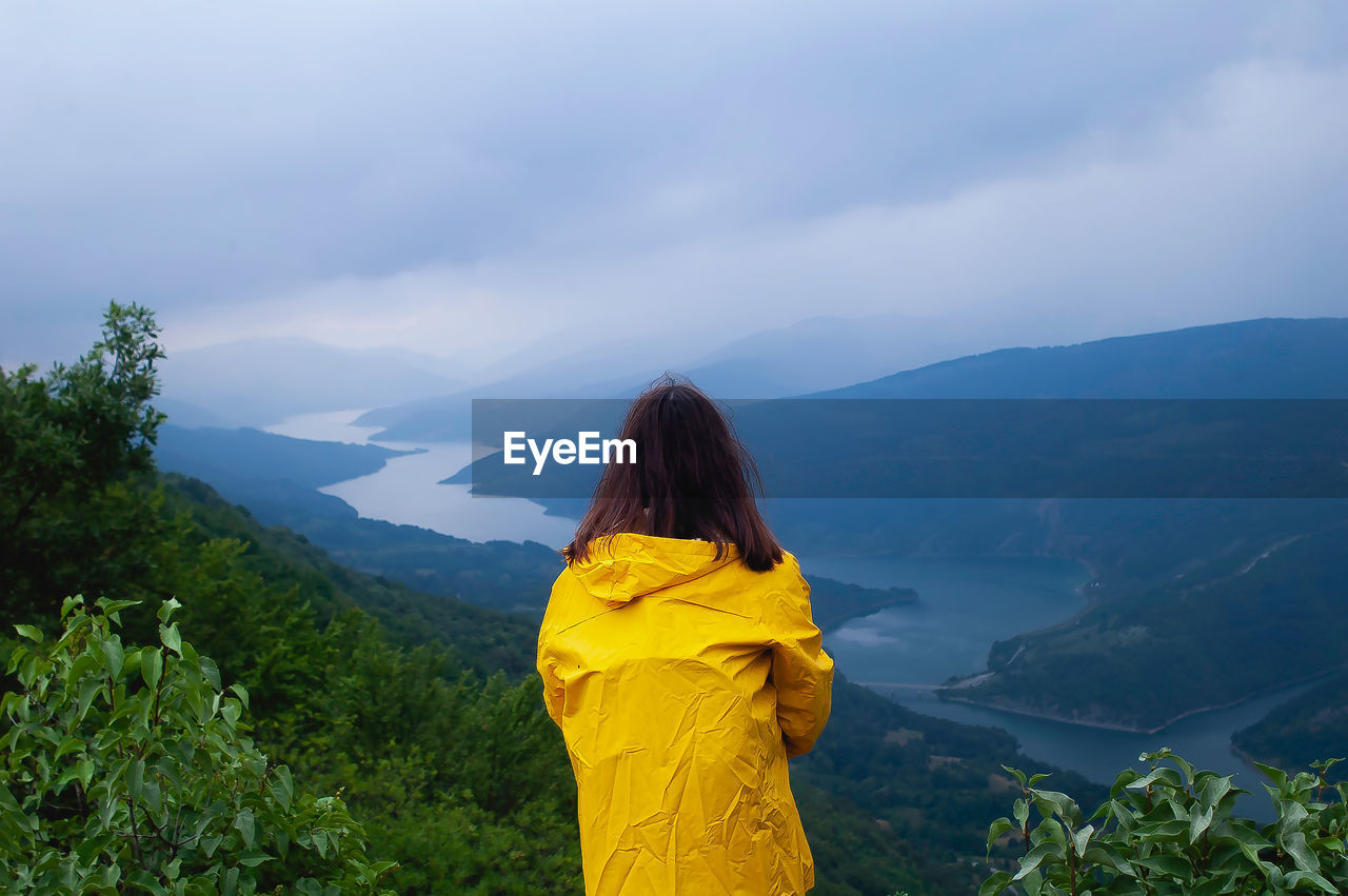 Rear view of woman standing on mountain