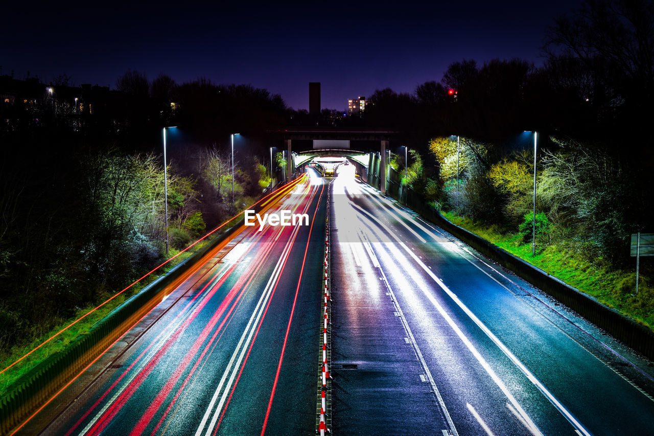 High angle view of light trails on highway at night